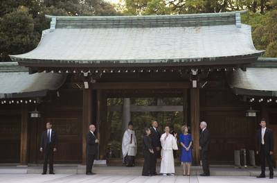 Touring With Friends - Chief priest Seitaro Nakajima, U.S. Ambassador to Japan, Caroline Kennedy, and her husband, Edwin Schlossberg, also joined the president on his tour of the Meiji Shrine.(Photo: AP Photo/Carolyn Kaster)