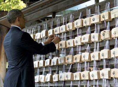Close and Friendly - The Meiji Shrine in Tokyo was another stop for the president on Thursday. Here, he is seen placing a prayer tablet on the Votive Tree. While in Japan, President Obama has gone out of his way to portray the U.S.-Japan relationship as friendly and close.&nbsp;(Photo: AP Photo/Carolyn Kaster)