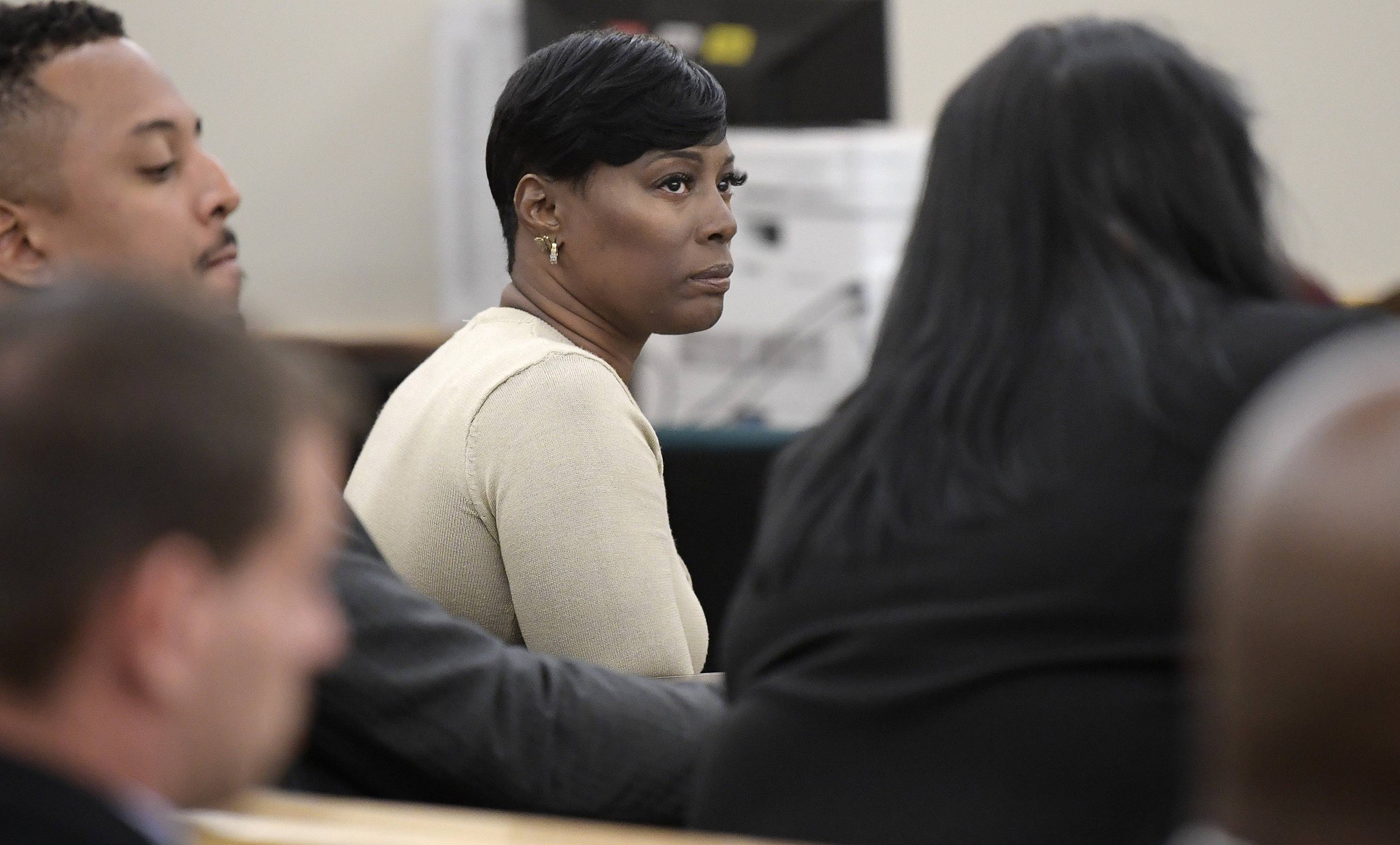 Crystal Mason, middle, convicted for illegal voting and sentenced to five years in prison, sitting at the defense table in Ruben Gonzalez's court at Tim Curry Justice Center in Fort Worth, Texas, on May 25, 2018. (Max Faulkner/Fort Worth Star-Telegram/TNS)