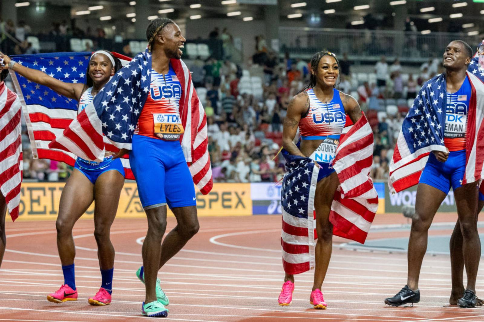 Noah Lyles of the United States and Sha'Carri Richardson of the United States celebrate the team's gold medal win in the Women's and Men's 4x100m Relay during the World Athletics Championships, at the National Athletics Centre on August 26th, 2023 in Budapest, Hungary. (Photo by Tim Clayton/Corbis via Getty Images)