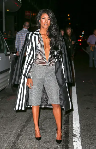 No Gripes With Stripes - Big sis of Jhene Aiko, singer-songwriter Mila J wears a striped top, shorts and trench while attending runway shows during New York Fashion Week.&nbsp;(Photo: Santi/Splash News)