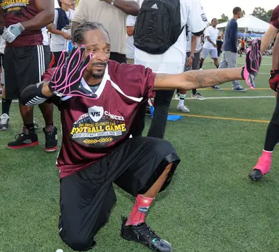 Mr. Football - Snoop Dogg&nbsp;poses in his uniform at the Athletes vs. Cancer 2nd Annual Celebrity Flag Football Event at Granada Hills Charter High School in Southern California.(Photo: Vladimir Labissiere/Splash News)