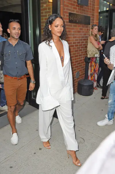 Bright White - Rihanna rocks a plunging white suit and nude heels at the Edun Fashion Show in New York City during Mercedes-Benz Fashion Week.&nbsp;(Photo: TS, PacificCoastNews)