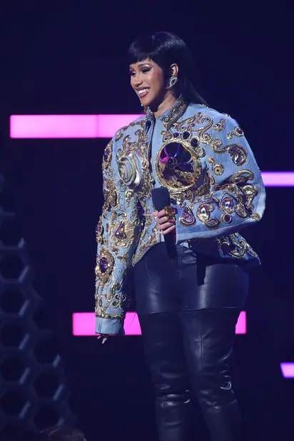 Cardi B's Louis Vuitton ponytail matches her crop top and skirt