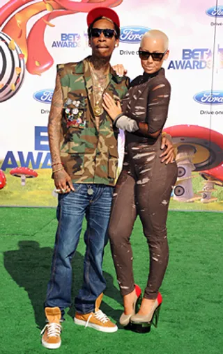 Designed to Last - &quot;I feel awesome in this outfit…and a little hot!” Amber Rose confided to us on the red carpet in 2011. The model flaunted her figure in a skintight jumpsuit. Wiz Khalifa stayed cool in a sleeveless camouflage vest and jeans. (Photo: Jason Merritt/Getty Images)