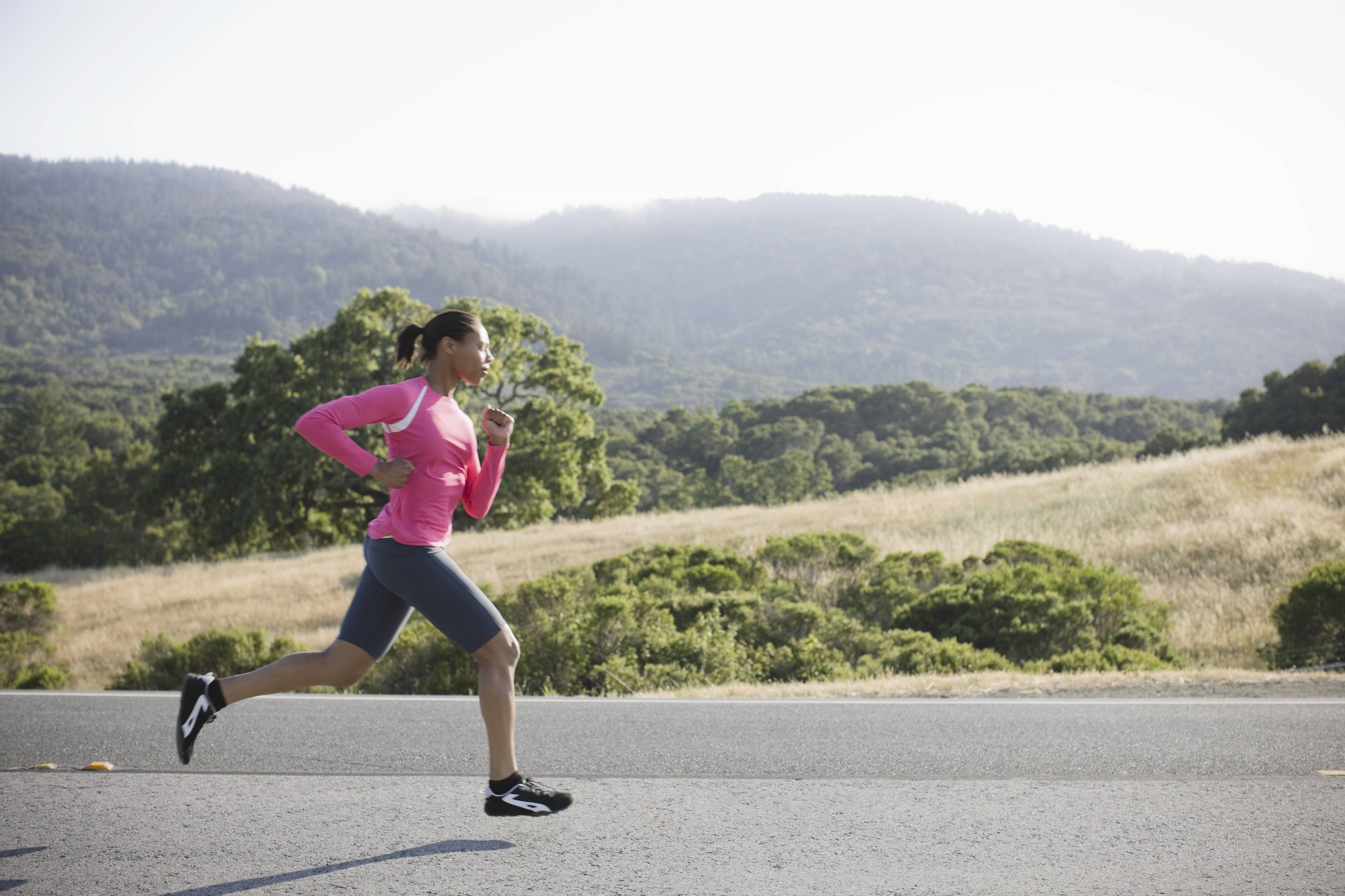 woman running outside in pink gear