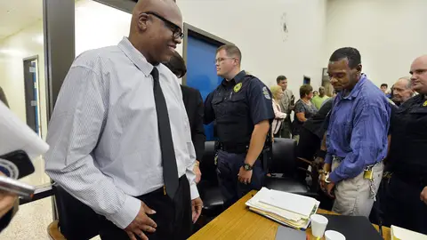 Leon Brown is all smiles as his brother Henry McCollum is led away by guards at the Robeson County Courthouse in Lumberton, N.C. Tuesday, September 2, 2014 after judge has declared McCollum and  Brown innocent of a brutal rape murder for which they have spent 30 years in prison. The brothers were convicted of the 1983 rape and murder of an 11-year-old girl whose body was found in a soybean field near the tiny town of Red Springs. Both were being taken back to their respective facilities to be processed and released. (Chuck Liddy/Raleigh News & Observer/MCT)