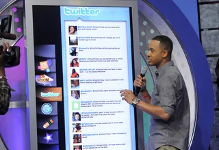 I Tweet - TJ checks audience responses to the Twitter topic #OnlyOnFriday at 106 &amp; Park, May 18, 2012. (photo: John Ricard / BET)