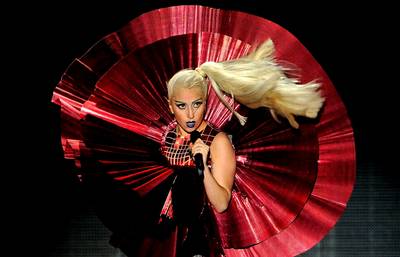4th Dimension \r - Singer Lady Gaga — always pushing the fashion envelope and, of course, taking live performance to the next level — appears onstage at the MTV Europe Music Awards in a futuristic red dress with twirling skirt at the Odyssey Arena in Belfast, Northern Ireland. (Photo: Gareth Cattermole/Getty Images)