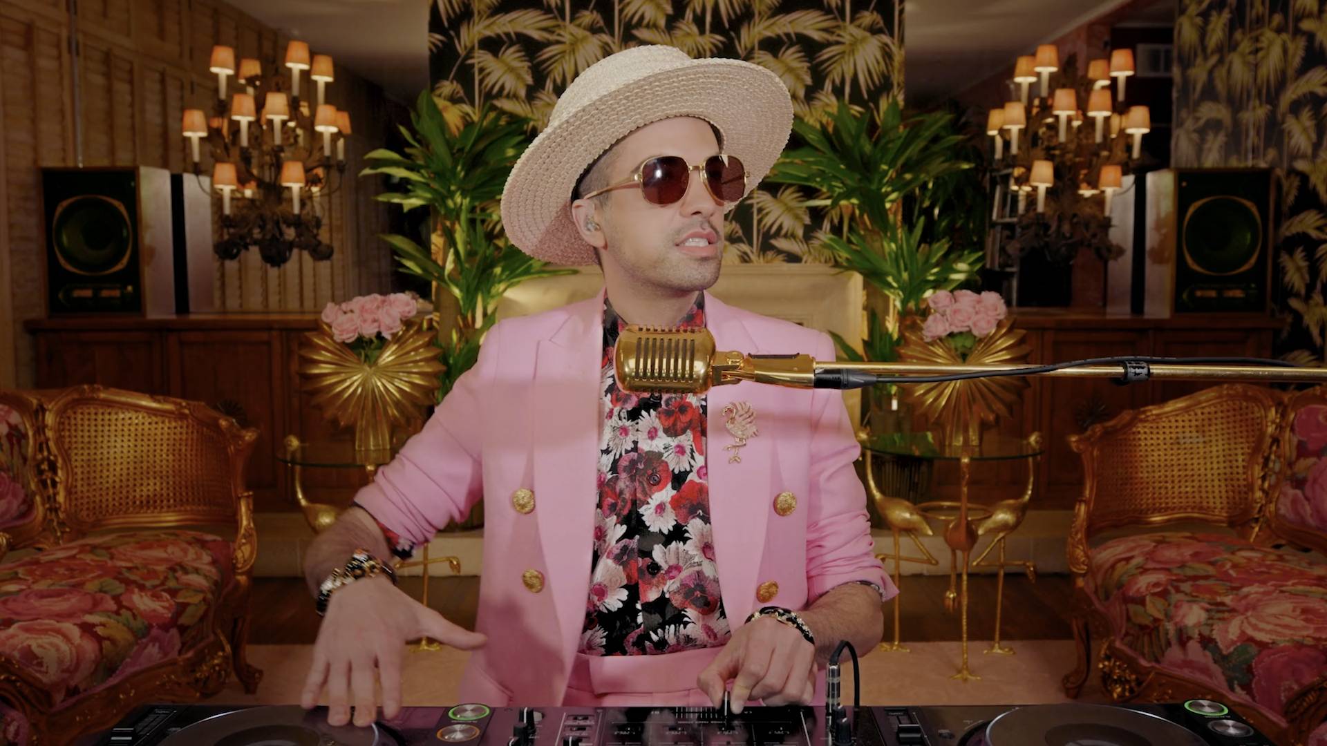 DJ Cassidy wearing a pink suit and spinning hits during DJ Cassidy's Pass the Mic: BET Awards Edition.
