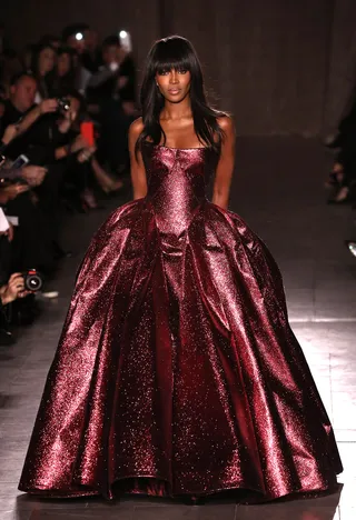 Zac Posen - All hail Queen Naomi! The runway legend reigns in Posen’s dazzling strapless ball gown. We’re obsessed with its ruby-metallic finish.   (Photo: Neilson Barnard/Getty Images)