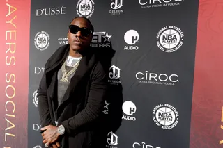 Hustle Hard - Ace Hood rocks sunglasses at night while posing on the red carpet.  (Photo: Gustavo Caballero/Getty Images for National Basketball Players Association)