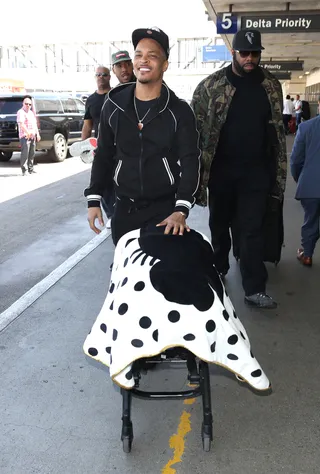 T.I. - T.I. took on daddy duties as he made his way through LAX while wheeling a baby stroller with his daughter in Los Angeles. (Photo: PacificCoastNews)