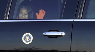 Peekaboo! - Sasha Obama sneaks in a wave through the limousine window. (Photo: AP Photo/Susan Walsh)