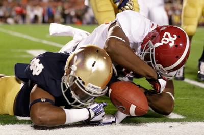 Gimme That! - Alabama's Landon Collins and Notre Dame's Davonte' Neal struggle over a fumbled punt. The ball went out of bounds and Notre Dame retained possession. (Photo: David J. Phillip/AP Photo)