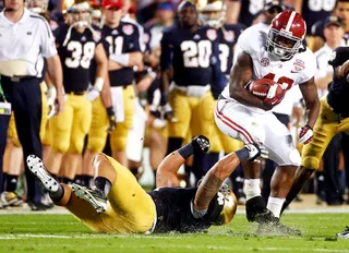 Down and Out - Notre Dame linebacker Manti Te'o misses an opportunity to stop Alabama's Eddie Lacy during the first half.(Photo: John Bazemore/AP Photo)