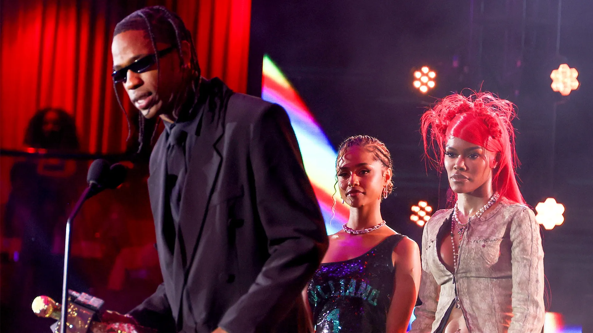 This is an image gallery photo of artist Travis Scott accepting the I Am Hip Hop Award from Tyla and Teyana Taylor onstage during the BET Hip Hop Awards 2024 at Drai's Beachclub & Nightclub on October 08, 2024 in Las Vegas, Nevada. 
