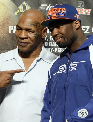 Heavy Hitters - Curtis 50 Cent&nbsp;Jackson poses with former heavyweight champion Mike Tyson on stage during the official weigh-in for Michael Farenas and Yuriorkis Gamboa at the MGM Grand Garden Arena in Las Vegas. (Photo: Jeff Bottari/Getty Images)