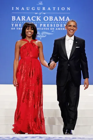 The First Couple - President Barack Obama and First Lady Michelle Obama re-emerged after the day's inaugural ceremonies at the Comander-in-Chief's Inaugural Ball at the Walter Washington Convention Center. Michelle Obama wore a red chiffon gown by designer Jason Wu.(Photo: Chip Somodevilla/Getty Images)