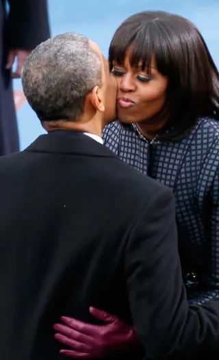 A Little Sugar - The president and first lady steal a kiss before the start of the ceremony. (Photo: Rob Carr/Getty Images)