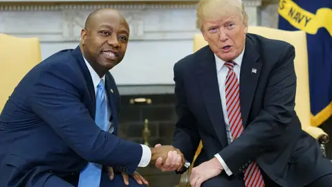 US President Donald Trump and Senator Tim Scott (L), R-SC, shake hands following a working session regarding opportunity zones following the recently signed tax bill in the Oval Office of the White House on February 14, 2018 in Washington, DC. / AFP PHOTO / MANDEL NGAN        (Photo credit should read MANDEL NGAN/AFP via Getty Images)