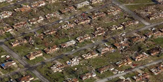 A Neighborhood Wiped Out - This aerial photograph shows a neighborhood destroyed by a powerful tornado in Joplin. (Photo: AP Photo/Charlie Riedel)