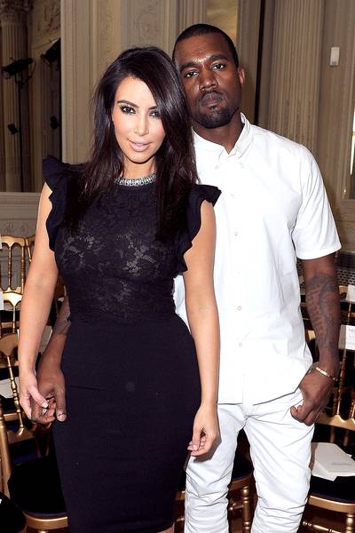 Kanye West and Kim Kardashian - Yeezy&nbsp;first met Kim in 2004 while she was married to Damon Thomas, but the rapper didn't see&nbsp;Kim until she appeared in a picture with BFF Paris Hilton back in 2006.  (Photo by Pascal Le Segretain/Getty Images)
