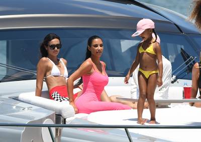 Kim And North Take Miami - North is literally Kim's mini me. North, along with her mom and Saint, was seen living her best life on a yacht sporting yellow bikini. (Photo: MEGA)