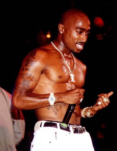 Tupac Shakur - Pac's Black Panther influence fueled his attacks on racist cops and Lady Liberty's unkept promises for racial equality. Like Malcolm, Makaveli wasn't afraid to bear arms and even set it off on police officers who were beating down a Black man. X's passion was also felt throughout Tupac's lyrics on songs like &quot;Words of Wisdom,&quot; where he kicked game like, &quot;Protect yourself, reach for what you want to do /&nbsp;Know thyself, teach by what we've been through /&nbsp;Armed with the knowledge of the place we've been /&nbsp;No one will ever oppress this race again /&nbsp;No Malcolm X in my history text, why's that? /&nbsp;’Cause he tried to educate and liberate all Blacks.&quot;&nbsp;(Photo: WENN)