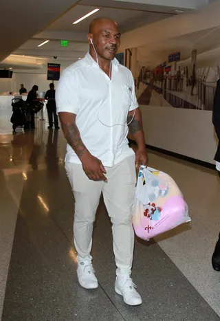 Magic Mike - Mike Tyson arrives with what looks like a gift for his daughter at LAX airport in Los Angeles.(Photo: Splash News)