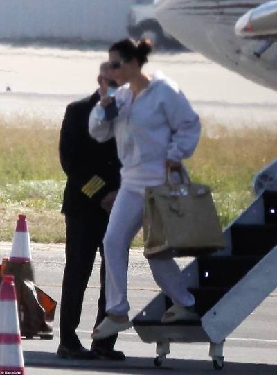 On The Go! - Kim Kardashian landed back in Los Angeles via private jet after visiting her husband, Kanye West in Wyoming. The business mogul headed straight to her Skims photoshoot wearing a comfy grey sweatsuit with Yeezy slippers carrying an oversized Hermès Birkin bag. She was visibly emotional while heading to the Range Rover that was waiting on her. We are praying for Kim, Kanye, and their family. (Photo: Backgrid) (Photo: Backgrid)