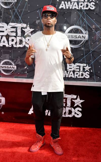 Drumma Boy - The hitmaker upgrades his plain white T-shirt and dark denim with some gold bling and flashy red high-tops. (Photo: Earl Gibson/BET/Getty Images for BET)