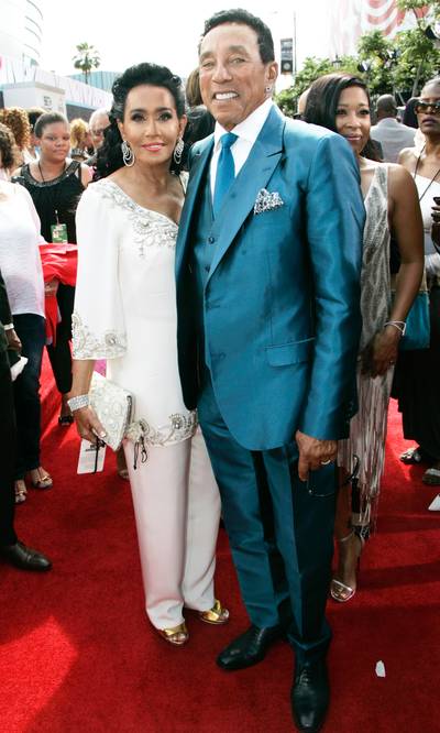 Smokey Robinson - The legendary crooner makes a splash in a metallic blue suit, while his wife, Frances, rides the summer-white trend in an embellished two-piece ensemble. Classy!  (Photo: Maury Phillips/BET/Getty Images for BET)