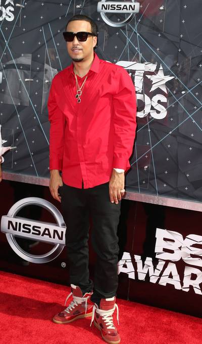 French Montana - Simple is better for the &quot;Don't Panic rapper&quot;, who steps out in a red button-down shirt topped off with gold-and-jewel pendants. Dark slacks and red metallic high-top sneaks finish the look. (Photo :Frederick M. Brown/Getty Images for BET)
