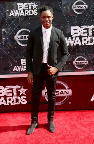 Avery Wilson - The singer keeps it classic in a sleek black suit, adding a black-and-white printed button-down for added flavor.   (Photo: Frederick M. Brown/Getty Images for BET)