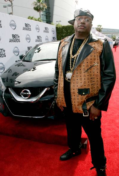 E-40 - The legendary rapper hits the carpet in a luxe leather jacket by MCM, styled with thick gold chains, black jeans and high-tops.   (Photo: Maury Phillips/BET/Getty Images for BET)