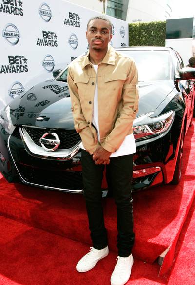 Vince Staples - The rapper keeps it cool in a camel-hued jacket, white T-shirt, slim black trousers and white high-tops.  (Photo: Maury Phillips/BET/Getty Images for BET)