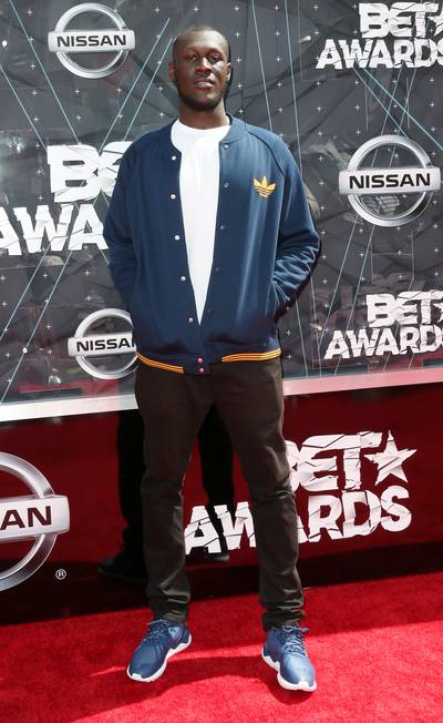 Stormzy - The British recording artist schools us on how to make a navy blue and blue work together. He meshes the hues together to make one stylish ‘fit. Guys, you better go cop an Adidas varsity ASAP!&nbsp; (Photo: Frederick M. Brown/Getty Images for BET)
