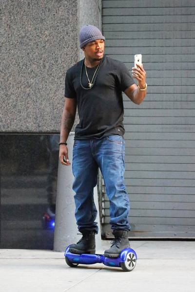 Get Your Roll On - Ne-Yo tries out his new self-balancing scooter while out and about in New York City(Photo: Felipe Ramales / Splash News)