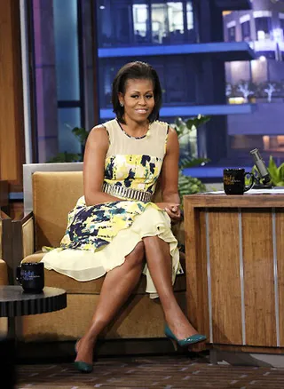 Statement Piece - Michelle Obama visits the Tonight Show with Jay Leno and Gabby Douglas in a belted yellow Bibhu Mohapatra dress boasting a vibrant print and delicate sheer inset.&nbsp;   (Photo: NBC)&nbsp;