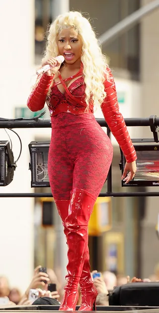 Racey Lace - Nicki Minaj dons a red lace one-piece jumpsuit with matching thigh-high patent leather boots and a pleather dominatrix-like shrug to perform on NBC's&nbsp;Today&nbsp;show at Rockefeller Plaza in New York City.(Photo: Michael Loccisano/Getty Images)