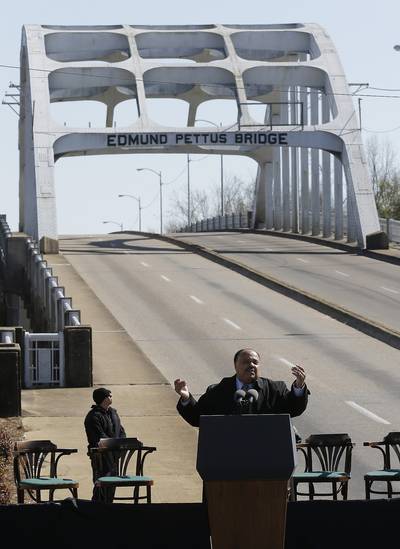 A Legacy - Martin Luther King III, son of slain civil rights leader Martin Luther King Jr., speaks to Bloody Sunday marchers.  (Photo: AP Photo/Dave Martin)