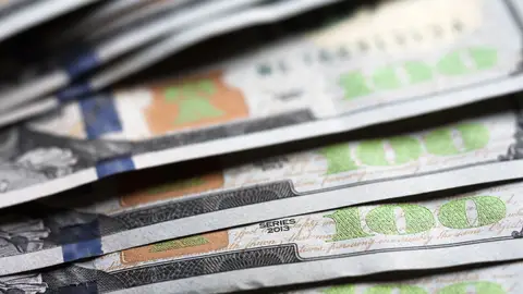 UKRAINE - 2020/07/09: A photo illustration of US 100 dollar bills. (Photo Illustration by Igor Golovniov/SOPA Images/LightRocket via Getty Images)