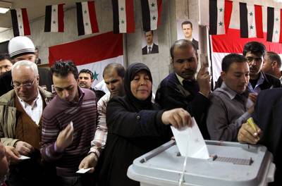 Syrians Vote Amid Violence - Syrians voted in a referendum in late Februrary and the results of the poll confirmed a new constitution that allows President Bashar al-Assad to remain in power until 2028. Although critics have called the vote a farce, Assad says the referendum shows his commitment to democratic reform.As the vote took place, at least 59 civilians and soldiers died in continued attacks.(Photo: REUTERS/Khaled al-Hariri)