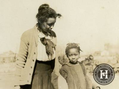 Helping Hands - African Americans did come from other communities to assist in Tulsa after the massacre. Here, Mrs. Ruth G. Fish of Alamosa, Colorado stands with a little girl referred to as &quot;Arizona.&quot;