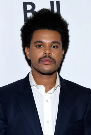 The Weekend - The Weeknd is sporting a new do! He was rocking a mini afro to the "Uncut Gems" premiere during the 2019 Toronto International Film Festival.&nbsp; (Photo: GP Images/Getty Images)