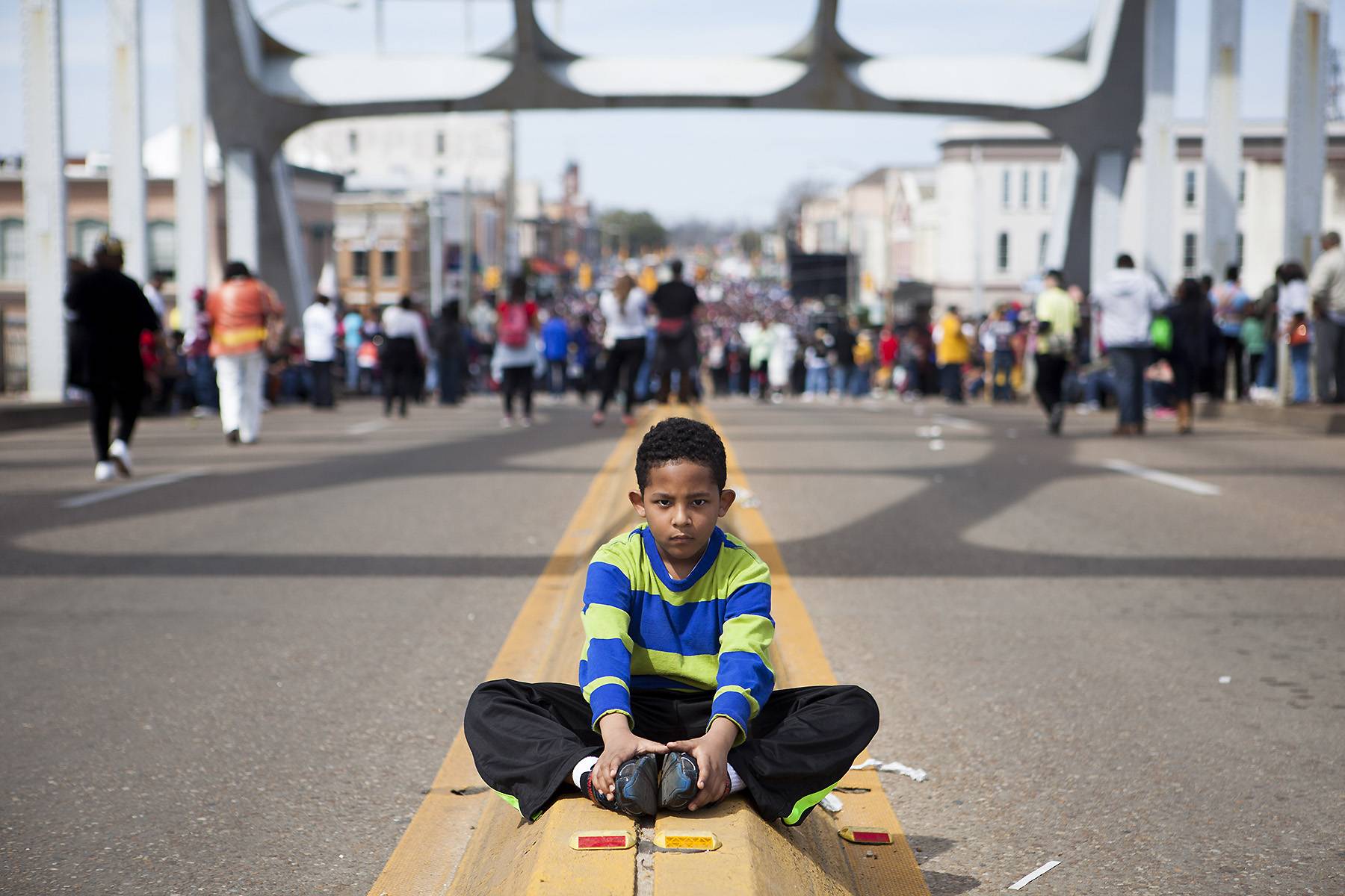 Young Soldier - A small child sits in the middle of the bridge staging a sit-in, a form of peaceful protest during the civil rights movement.&nbsp;(Photo: Ty Wright/BET)