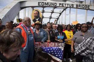 Never Forget - Flyers of Dr. Martin Luther King fly high as people neared the end of the bridge. &nbsp;#RememberSelma50&nbsp;(Photo: Ty Wright/BET)