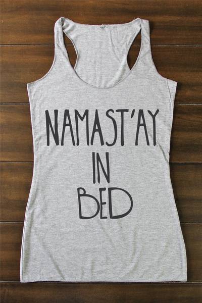 Arima Designs 'Namast'ay in Bed' Yoga Shirt ($26) - Flash your funny bone in this cheeky slogan tank and you're bound to make a few more friends in class.  (Photo: ArimaDesigns via Etsy)
