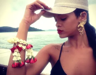 Enter the Dragon - We can’t decide which we adore more: the singer’s golden dragon ear cuff or her bracelet fashioned from delicate roses. Both are absolutely ravishing against Rih’s red-hot lipstick.  (Photo: Rihanna via Instagram)